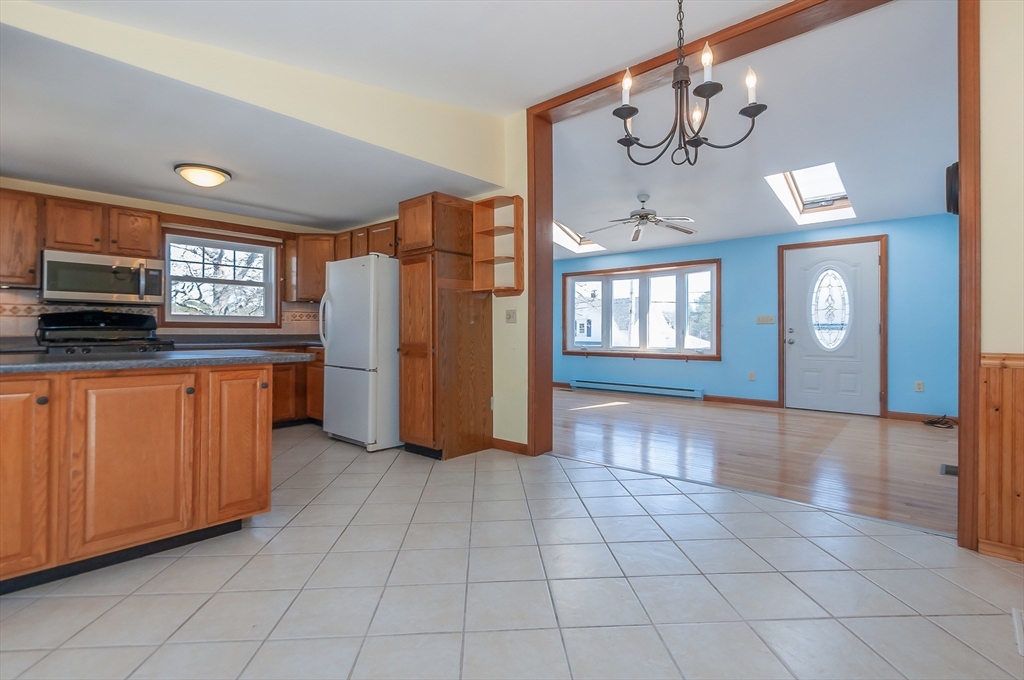 7 Roosevelt Street Wareham, MA 02571 - Photo 9 of 29 a kitchen with stainless steel appliances granite countertop a refrigerator and a stove top oven
