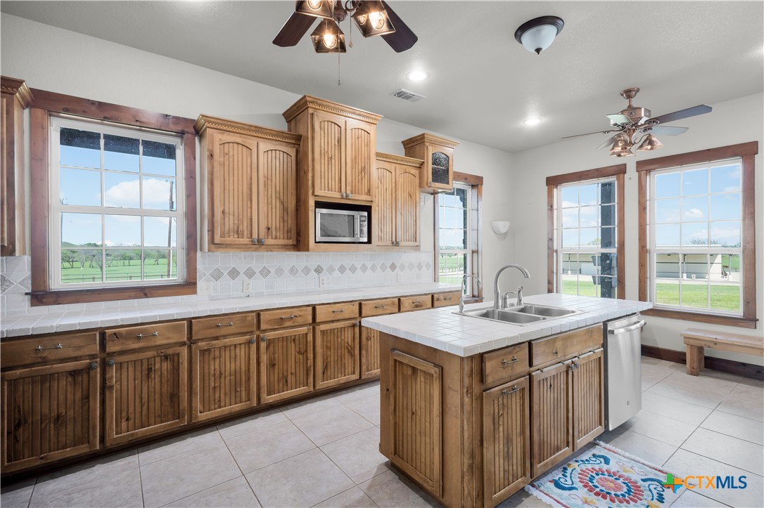 12491 Madison Lane Justin, TX 76247 - Photo 18 of 38 a kitchen with a sink stove and cabinets