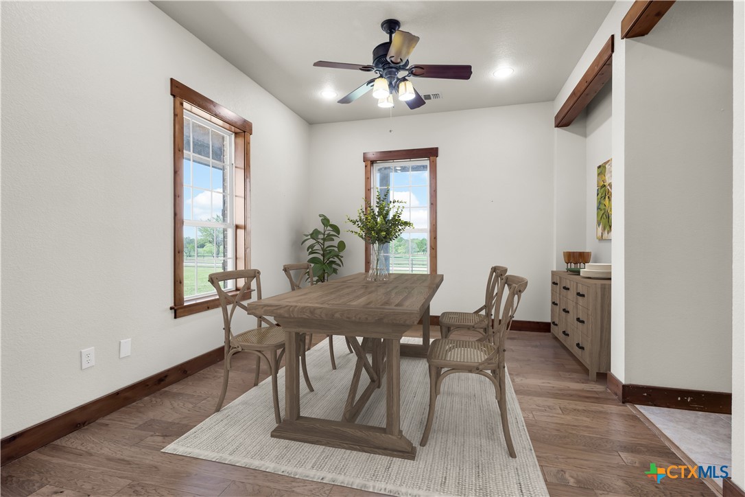 12491 Madison Lane Justin, TX 76247 - Photo 20 of 38 a view of a dining room with furniture and a chandelier