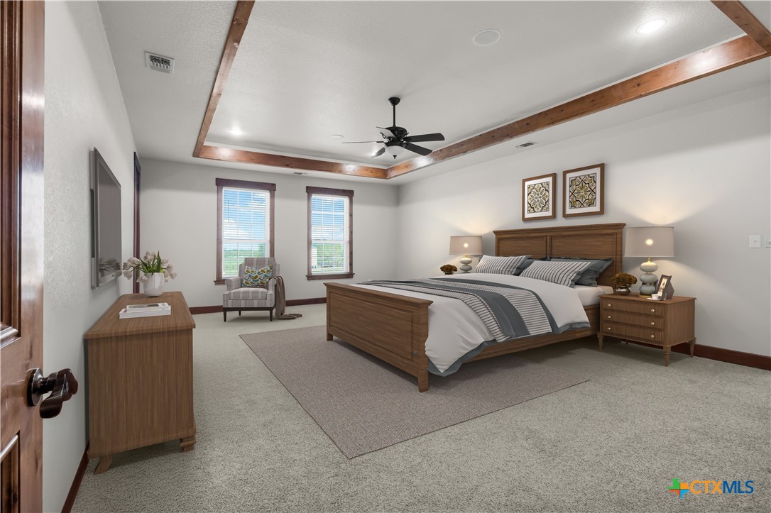 12491 Madison Lane Justin, TX 76247 - Photo 21 of 38 a spacious bedroom with a bed a couch and a chandelier
