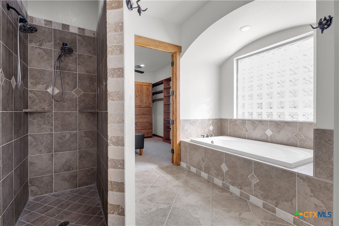 12491 Madison Lane Justin, TX 76247 - Photo 24 of 38 a bathroom with a bathtub and a shower