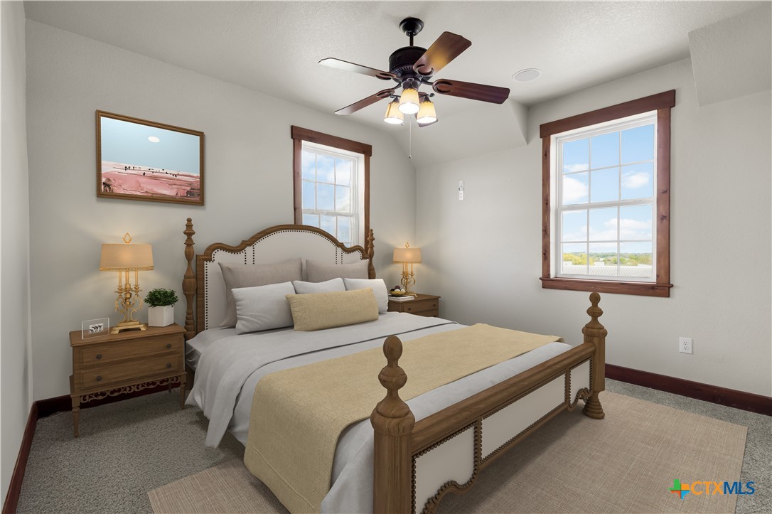 12491 Madison Lane Justin, TX 76247 - Photo 25 of 38 a bedroom with a bed and a chandelier