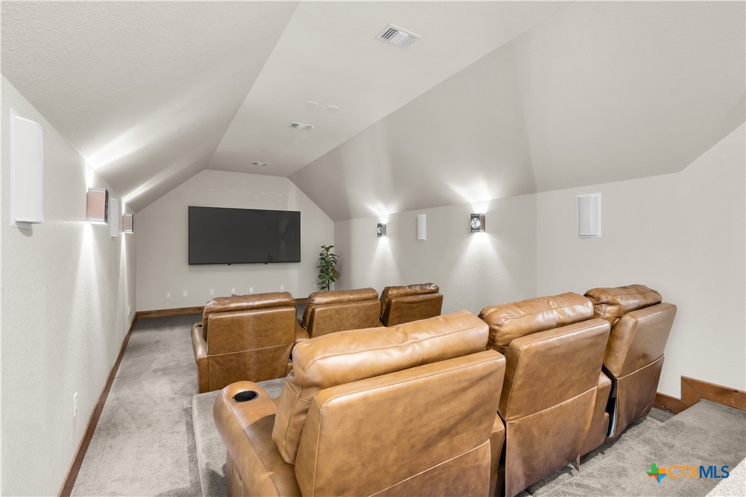 12491 Madison Lane Justin, TX 76247 - Photo 27 of 38 a projector room with furniture and a flat screen tv