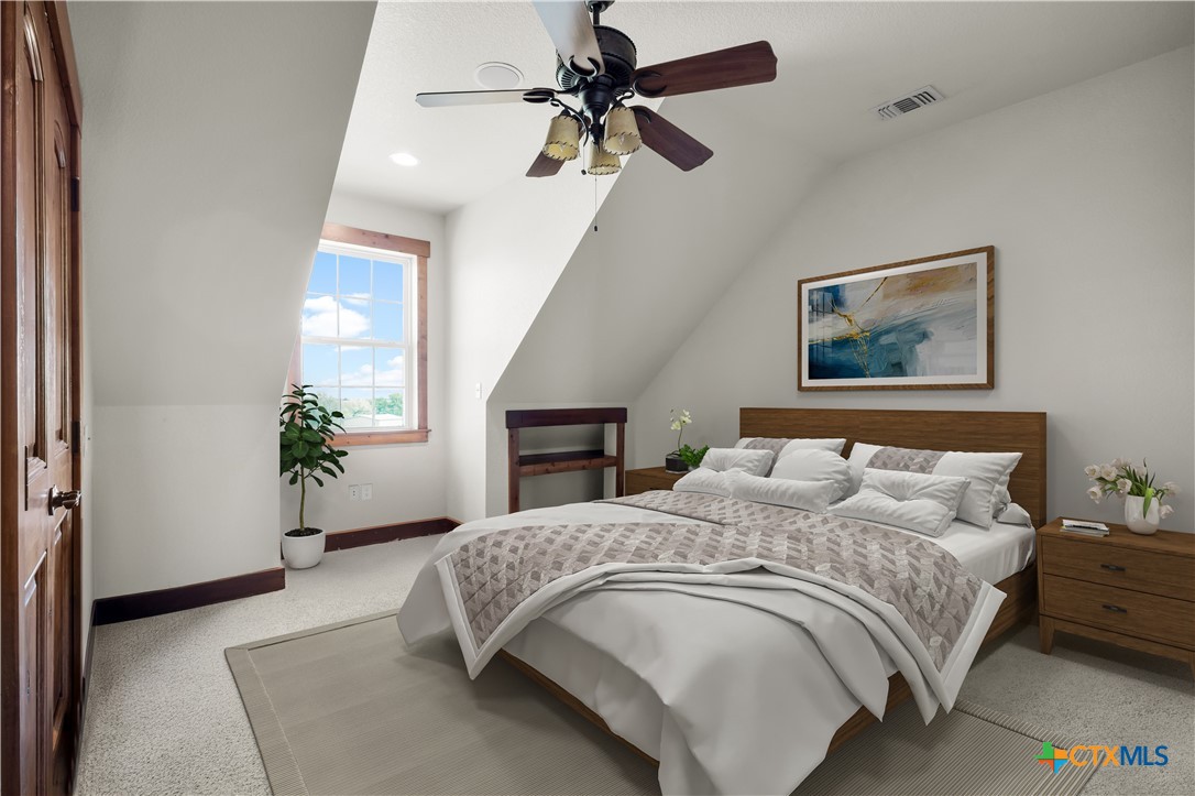 12491 Madison Lane Justin, TX 76247 - Photo 29 of 38 a bedroom with a bed and a chandelier