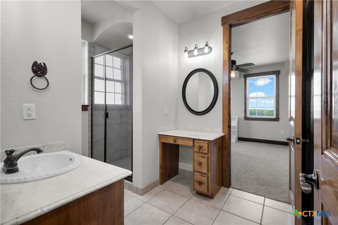 12491 Madison Lane Justin, TX 76247 - Photo 30 of 38 a bathroom with a toilet a sink and a mirror