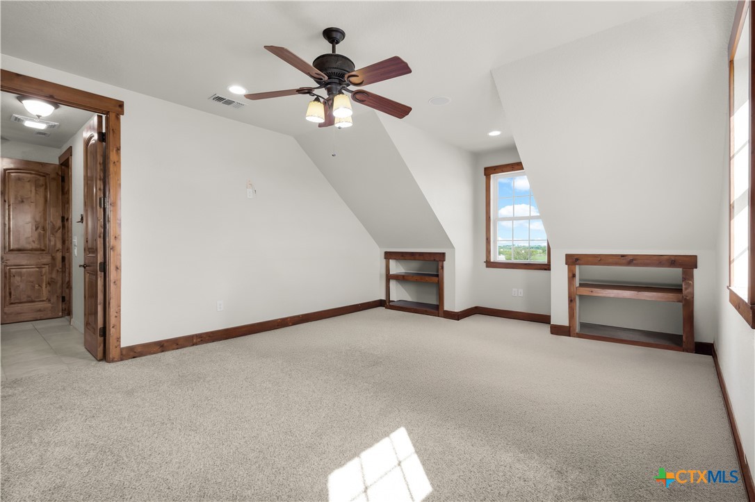 12491 Madison Lane Justin, TX 76247 - Photo 32 of 38 an empty room with windows and fan