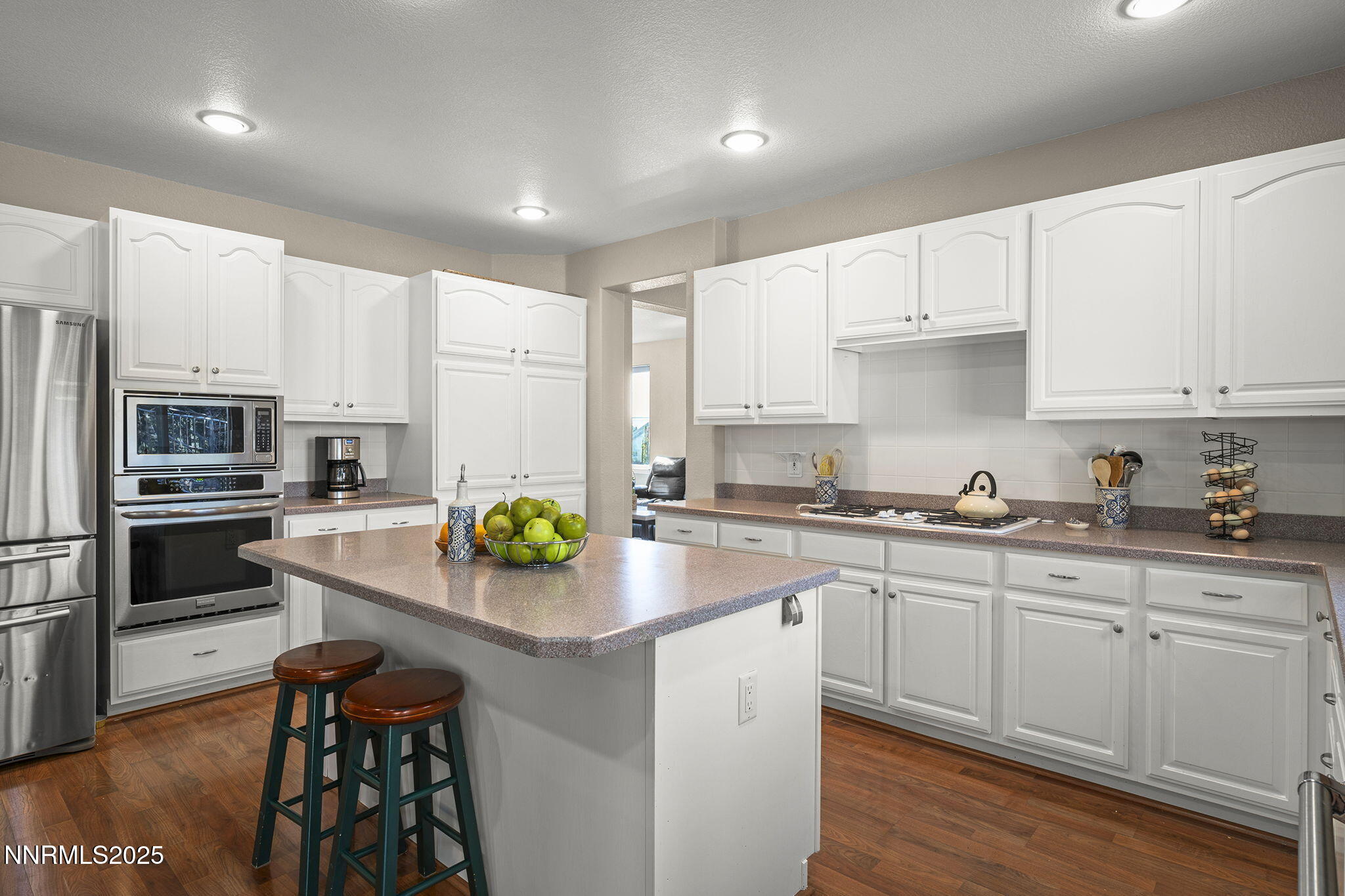 7159 Windstar Drive Reno, NV 89523 - Photo 11 of 33 a kitchen with stainless steel appliances a sink a stove a refrigerator cabinets and a window