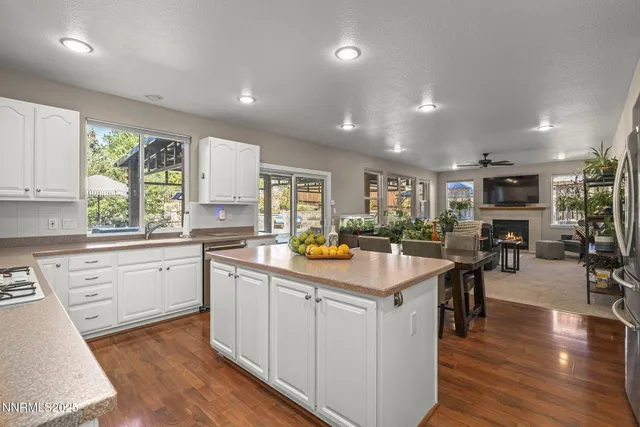 a kitchen with sink and wooden floor