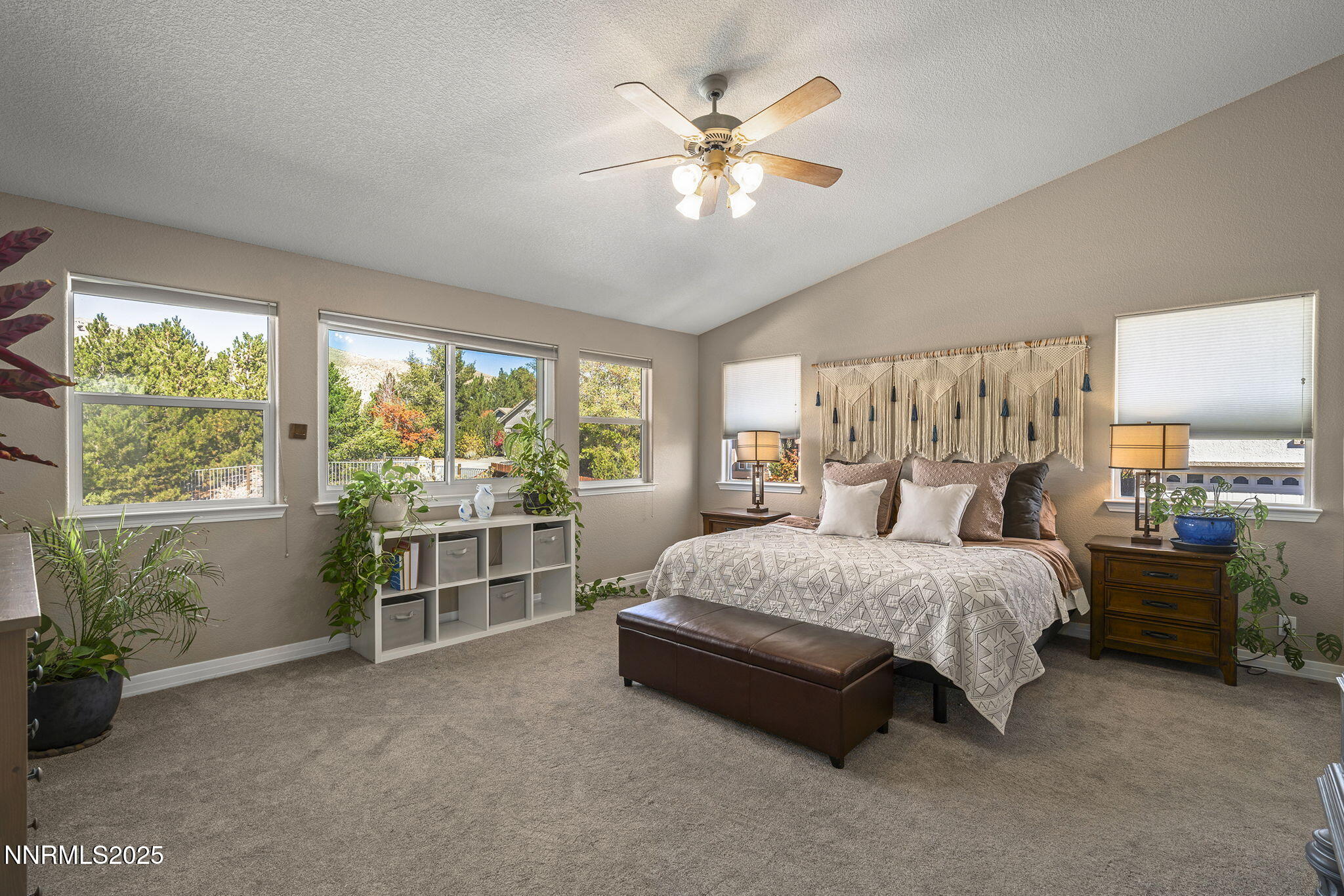 7159 Windstar Drive Reno, NV 89523 - Photo 13 of 33 a bedroom with a large bed and a chandelier fan