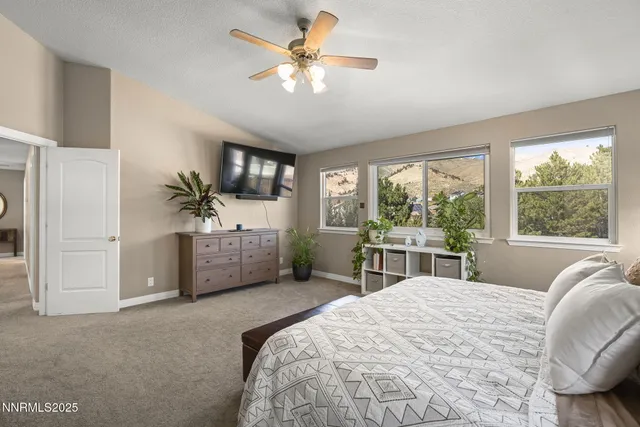 a bedroom with a large bed and a large window