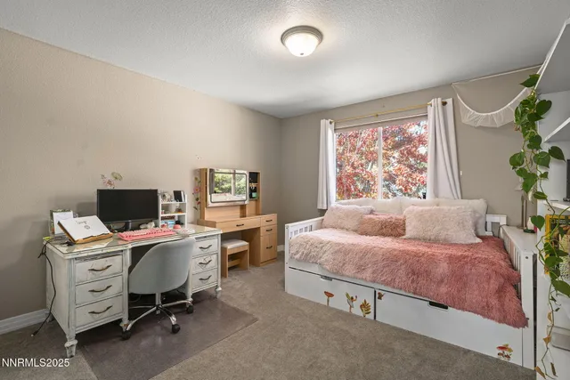 a bedroom with a workspace