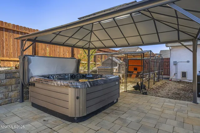 a view of a patio with table and chairs under an umbrella