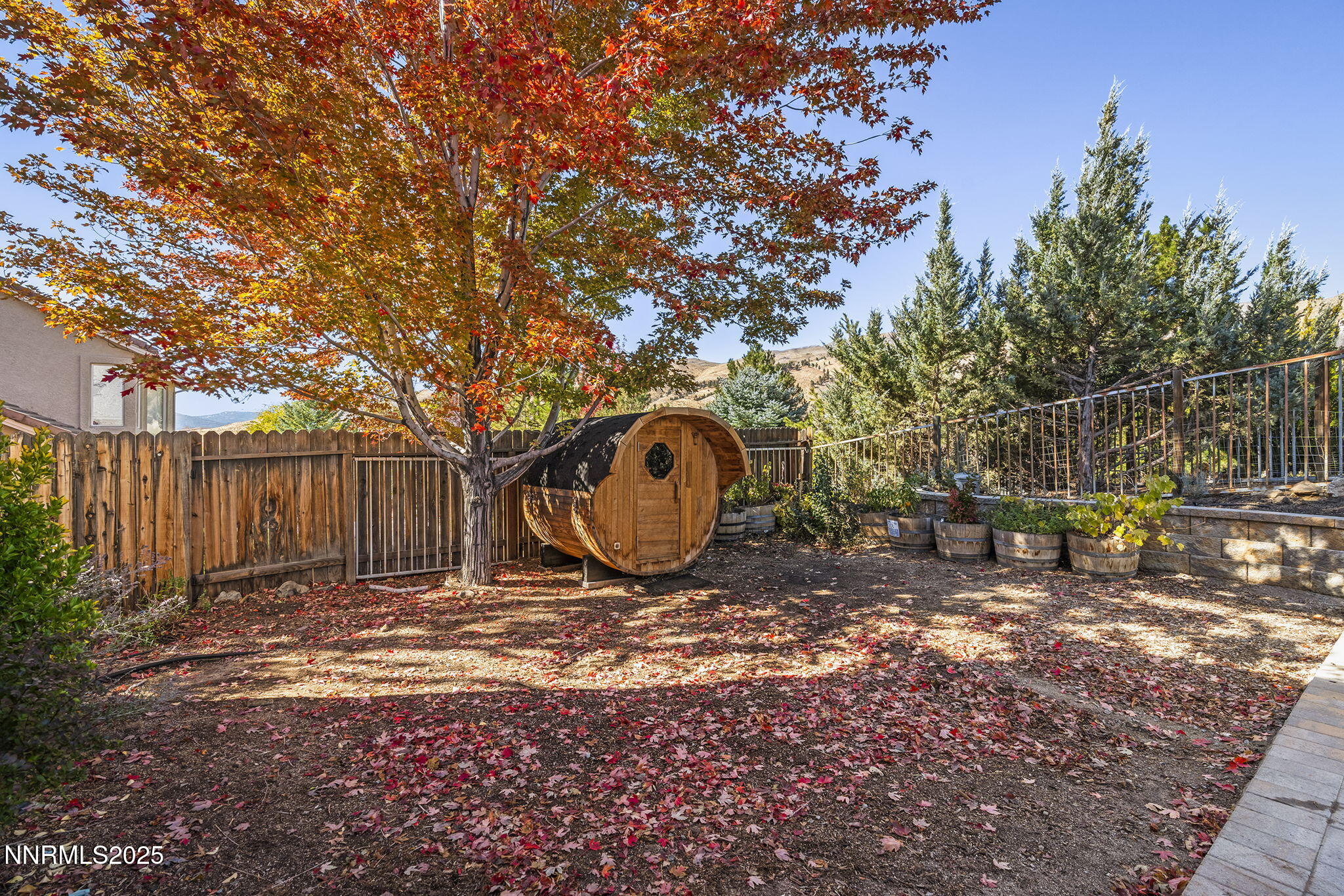 7159 Windstar Drive Reno, NV 89523 - Photo 33 of 33 a view of a backyard with large trees and wooden fence