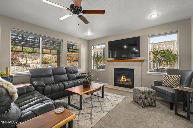 a living room with furniture a flat screen tv and a fireplace