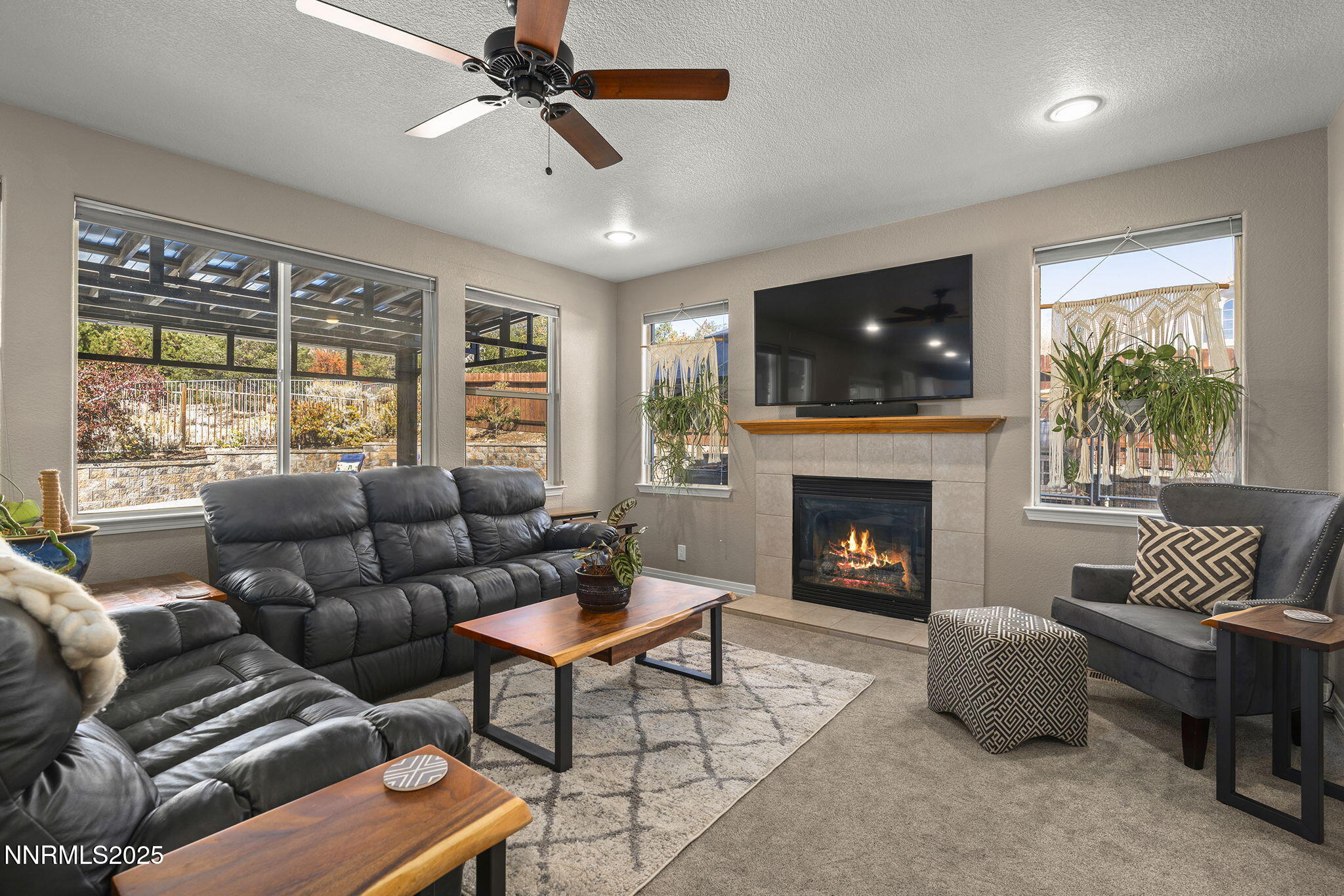 7159 Windstar Drive Reno, NV 89523 - Photo 8 of 33 a living room with furniture a flat screen tv and a fireplace