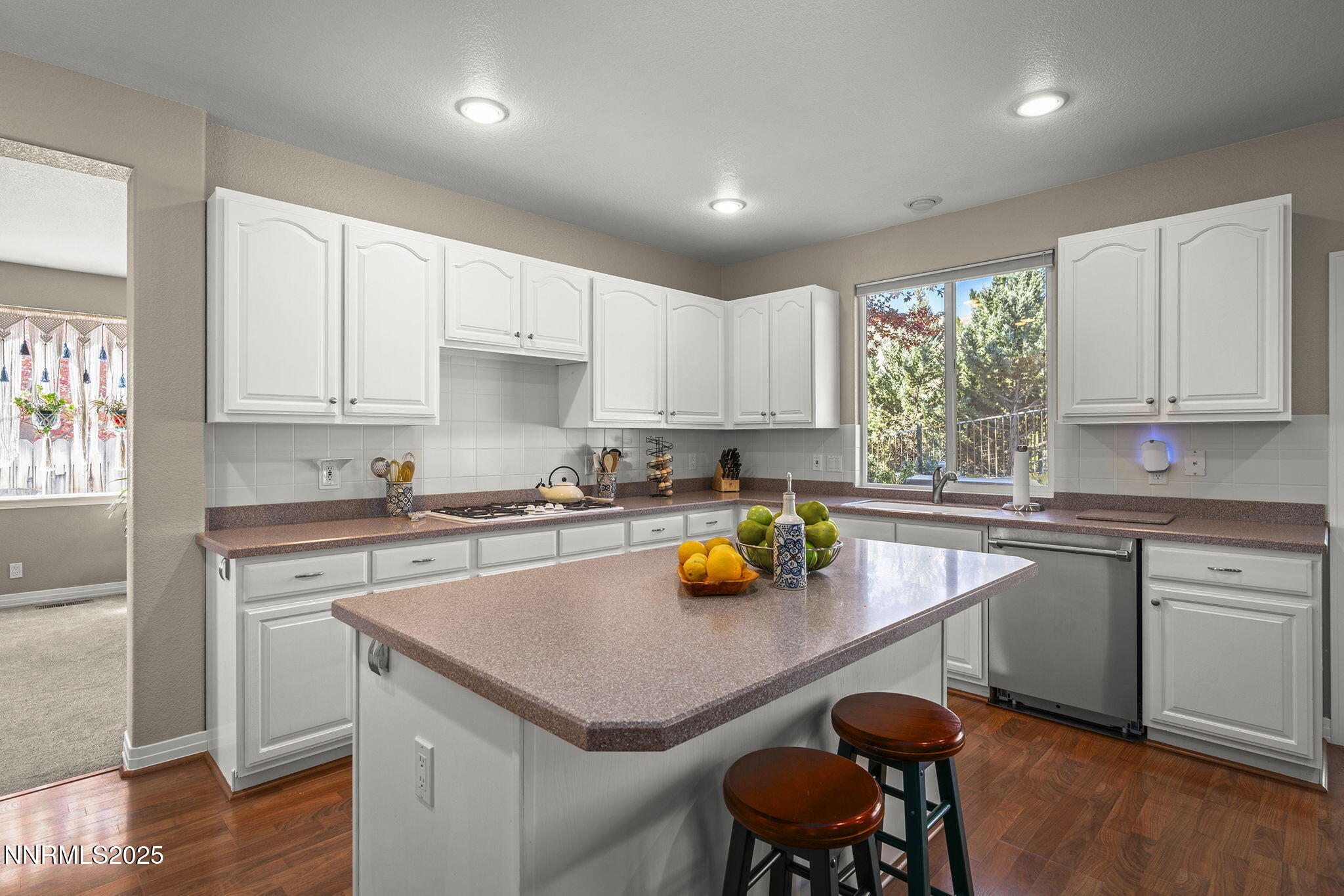 7159 Windstar Drive Reno, NV 89523 - Photo 10 of 33 a kitchen with a sink white cabinets and wooden floor