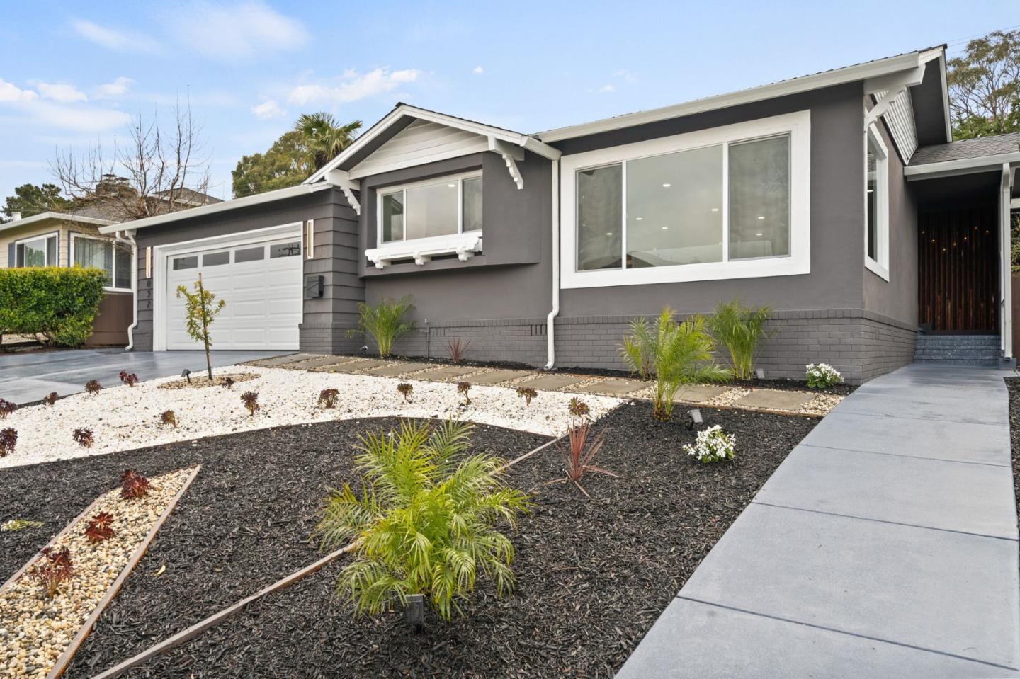 a front view of a house with garden