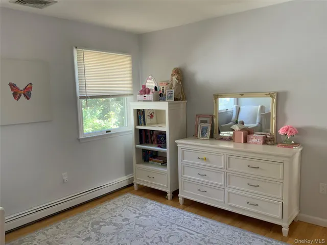 a room with a dresser and a mirror