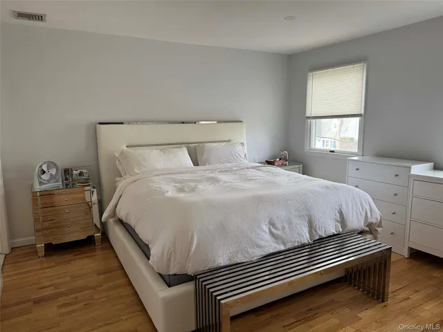 a bed sitting in a bedroom next to a window