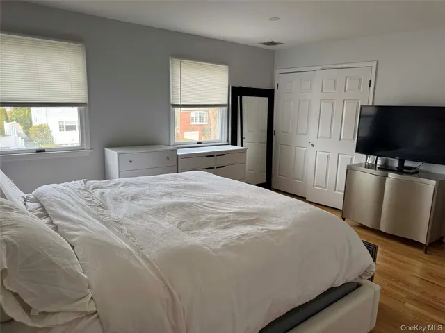 a bedroom with a bed and a flat screen tv