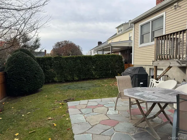 a view of backyard of house with seating space