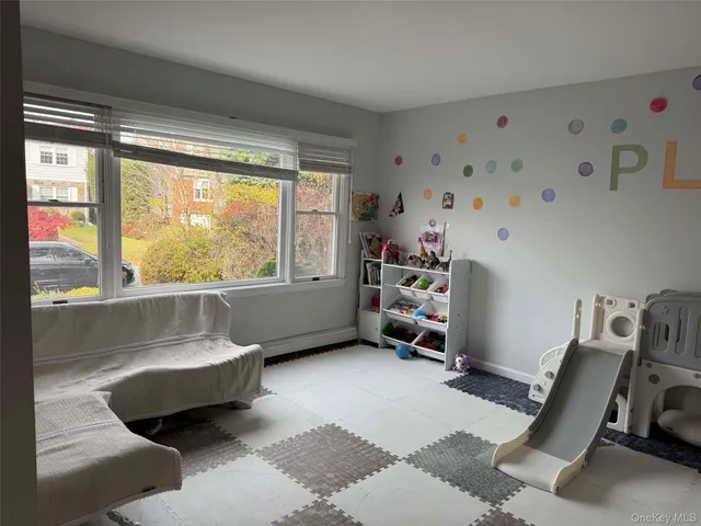 a bedroom with furniture and a large window