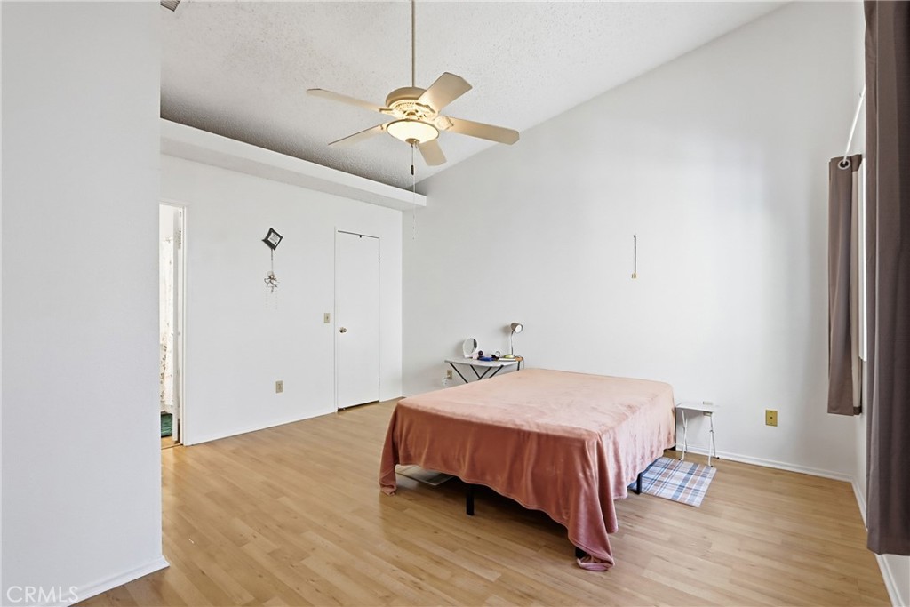 29350 Murrieta Road Menifee, CA 92586 - Photo 20 of 31 a bedroom with a bed and wooden floor