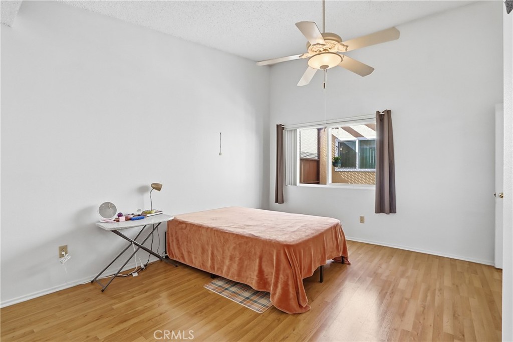 29350 Murrieta Road Menifee, CA 92586 - Photo 21 of 31 a bedroom with a bed and a chandelier