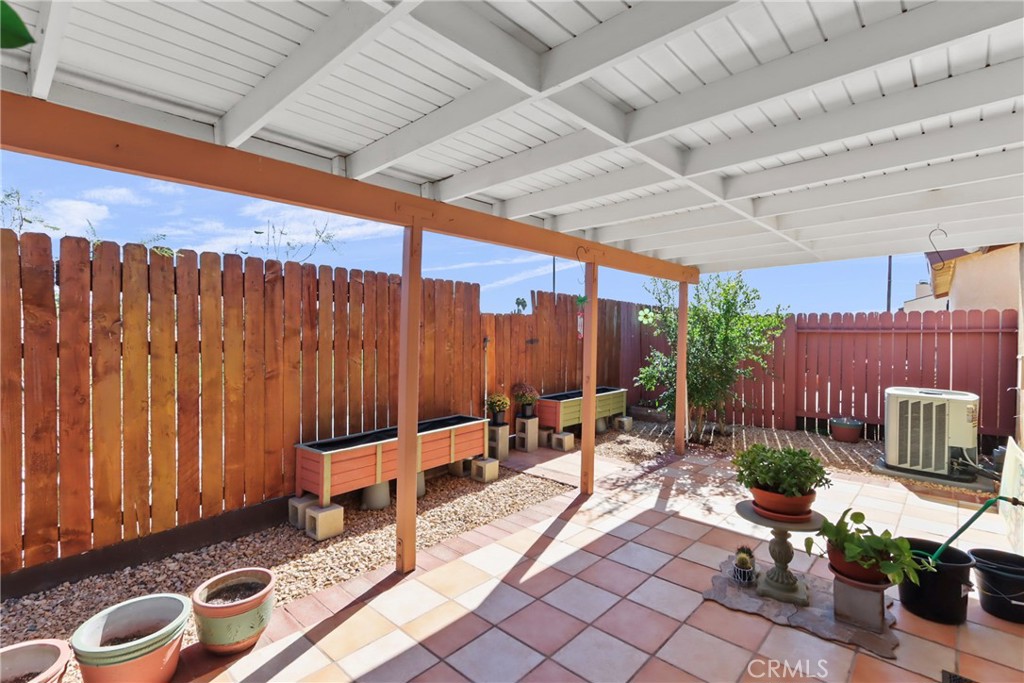29350 Murrieta Road Menifee, CA 92586 - Photo 28 of 31 a view of a patio with table and chairs potted plants and a barbeque