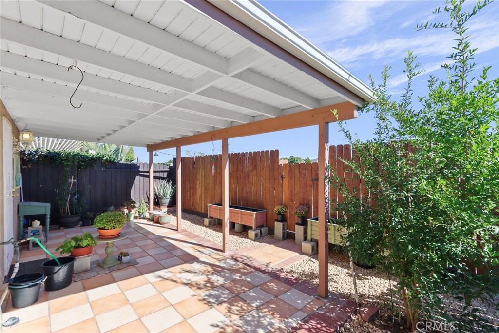 29350 Murrieta Road Menifee, CA 92586 - Photo 30 of 31 a view of a backyard with table and chairs potted plants and large tree