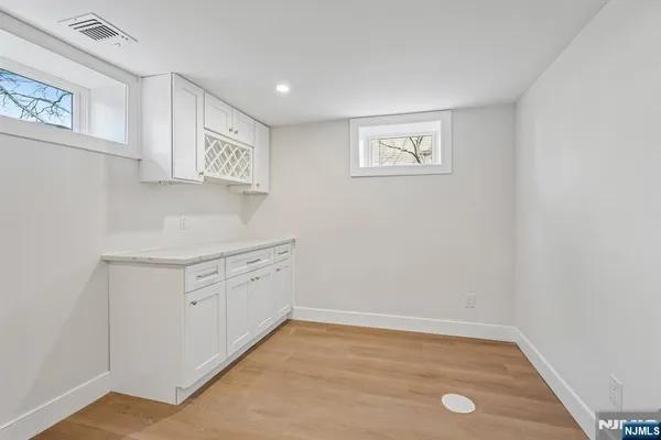 a view of a kitchen with white cabinets