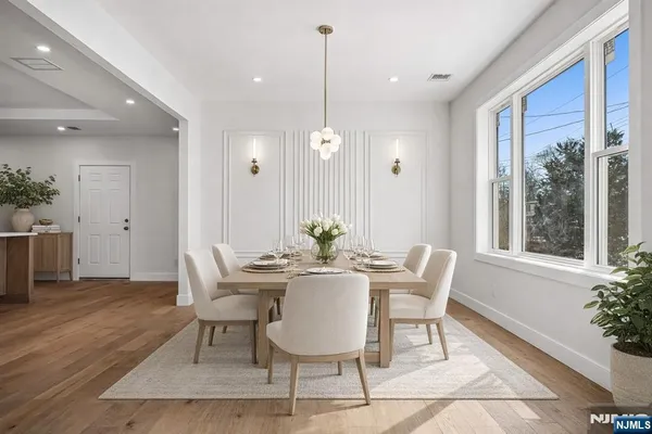 a view of a dining room with furniture window and wooden floor
