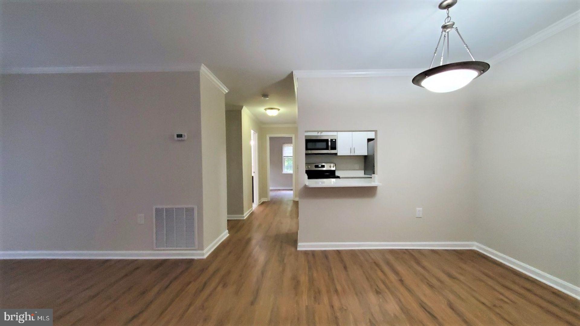 18308 Streamside Drive, Unit 101 Gaithersburg, MD 20879 - Photo 8 of 20 a view of kitchen and wooden floor