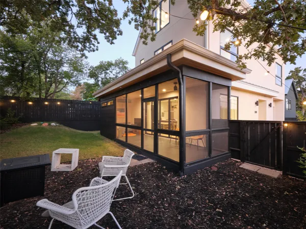 a view of backyard with deck and outdoor seating