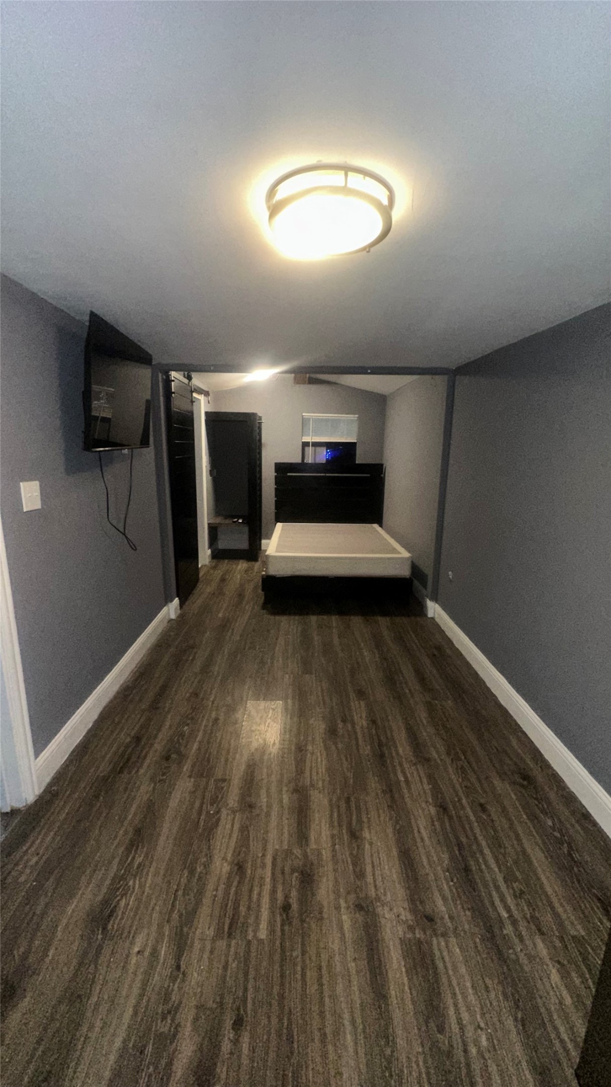 414 Frydek Road Sealy, TX 77474 - Photo 9 of 22 a view of a hallway with wooden floor and a fireplace