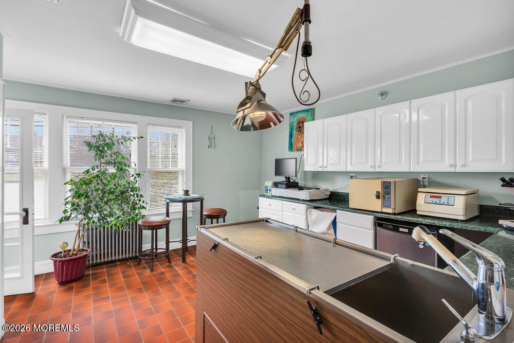 34 State Route Colts Neck, NJ 07722 - Photo 22 of 40 a open kitchen with stainless steel appliances granite countertop a sink a stove and wooden floors