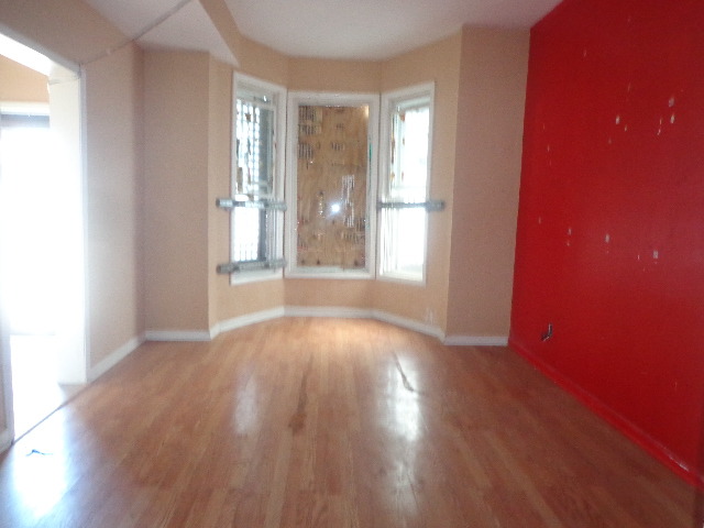 6016 South Aberdeen Street Chicago, IL 60621 - Photo 2 of 5 an empty room with wooden floor and windows