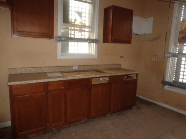 6016 South Aberdeen Street Chicago, IL 60621 - Photo 4 of 5 a room with granite countertop cabinets sink and window