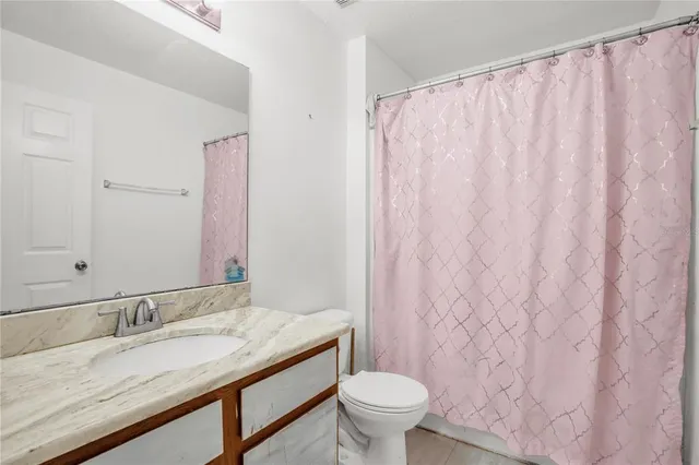 a bedroom with a bed and flat screen tv