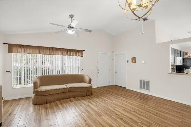 a living room with a couch and wooden floor