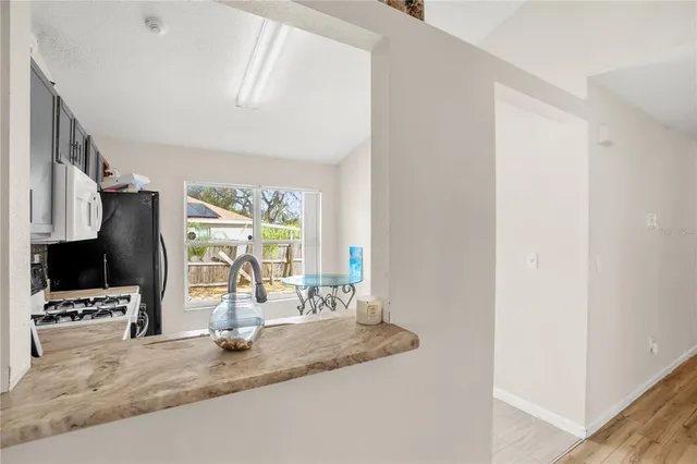 a kitchen with stainless steel appliances a sink and a refrigerator