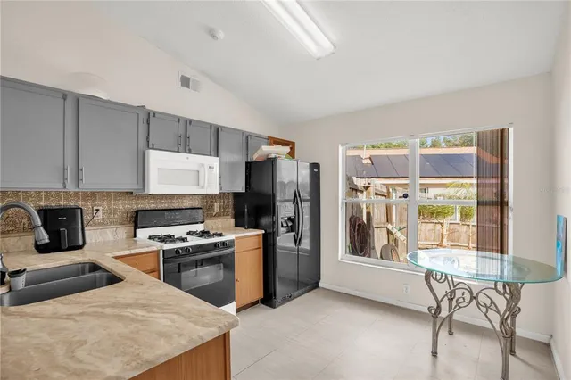 a kitchen with a refrigerator sink and stove