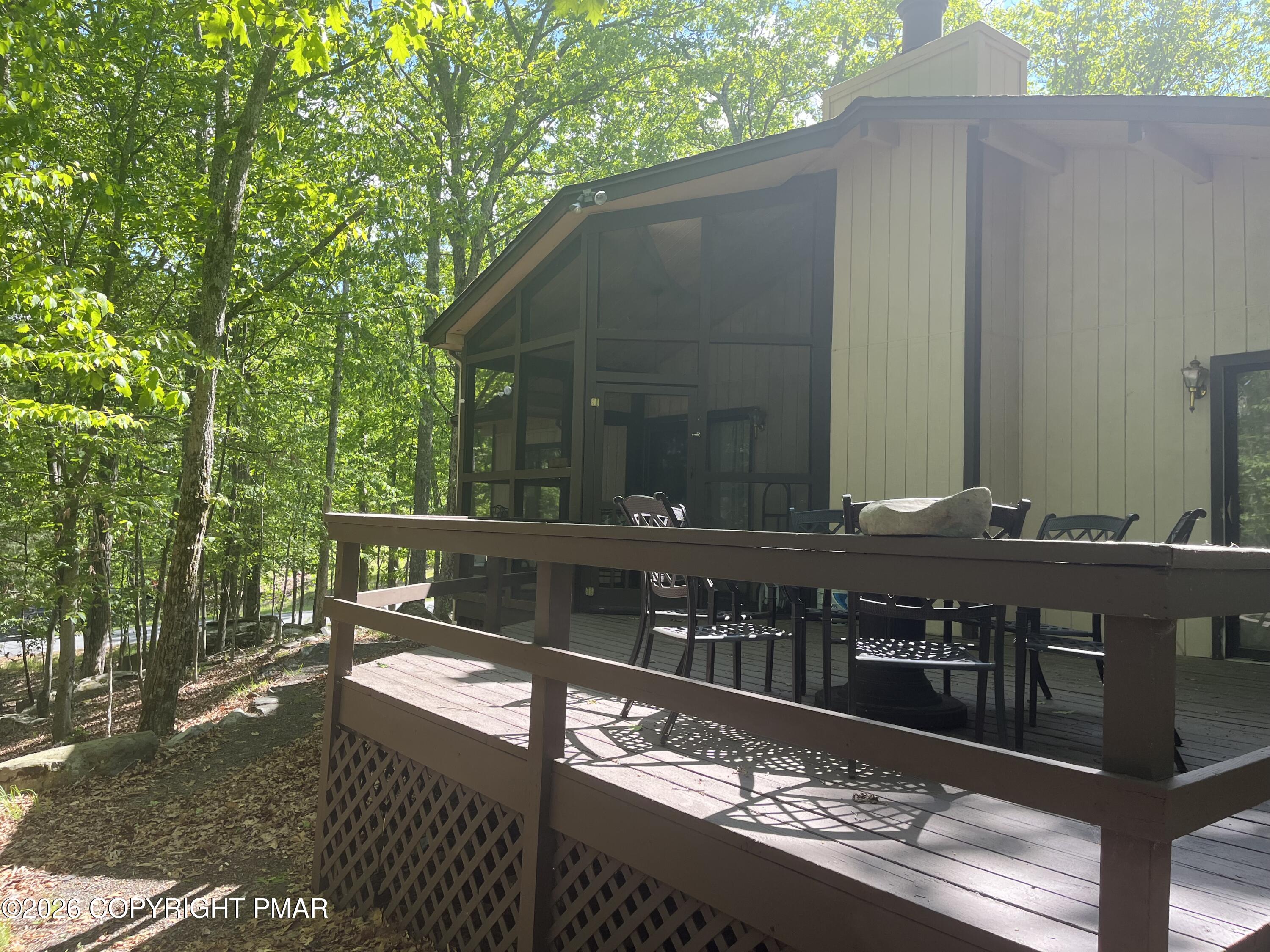 5970 Decker Road Bushkill, PA 18324 - Photo 4 of 26 a view of house with backyard and a chair