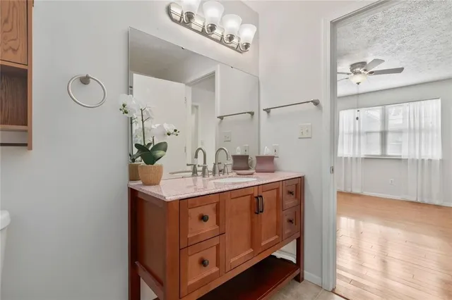 an empty room with a hardwood and ceiling fan