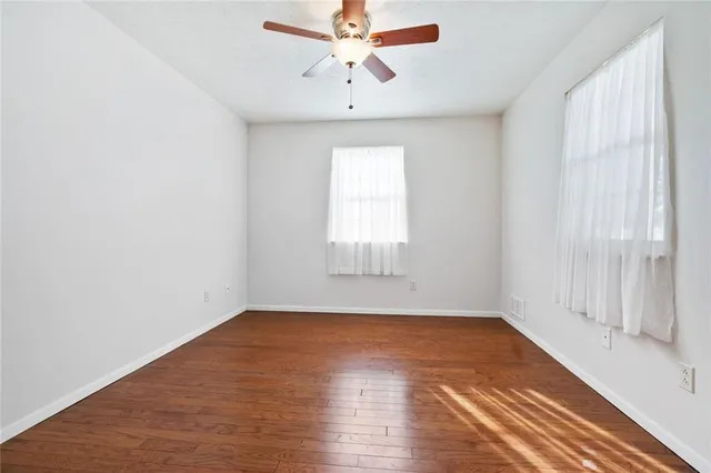 a spacious bedroom with a bed and a chandelier
