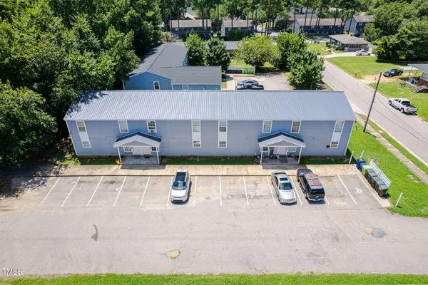 an aerial view of a house with garden space and street view
