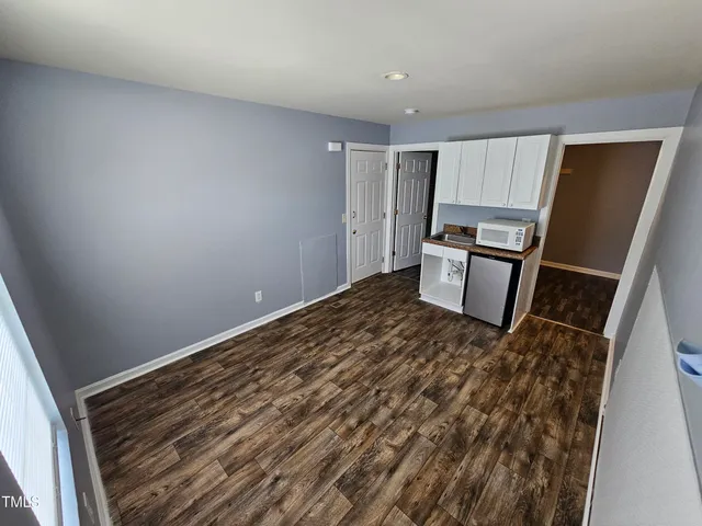 a view of a kitchen with wooden floor