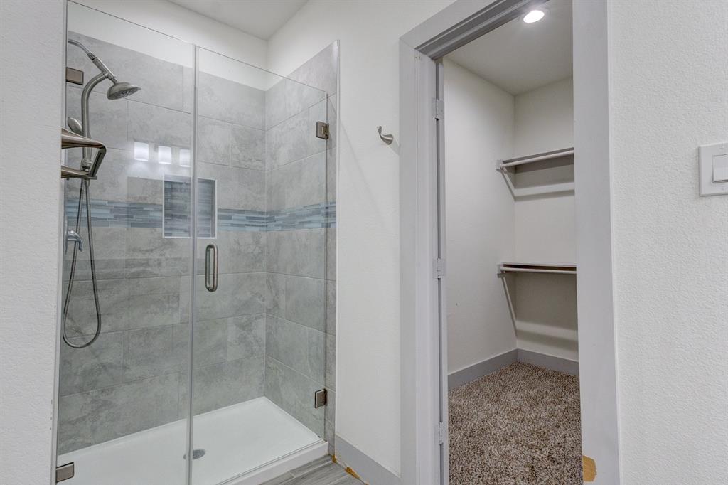 6043 Rivendell Drive Frisco, TX 75035 - Photo 21 of 38 a bathroom with a shower
