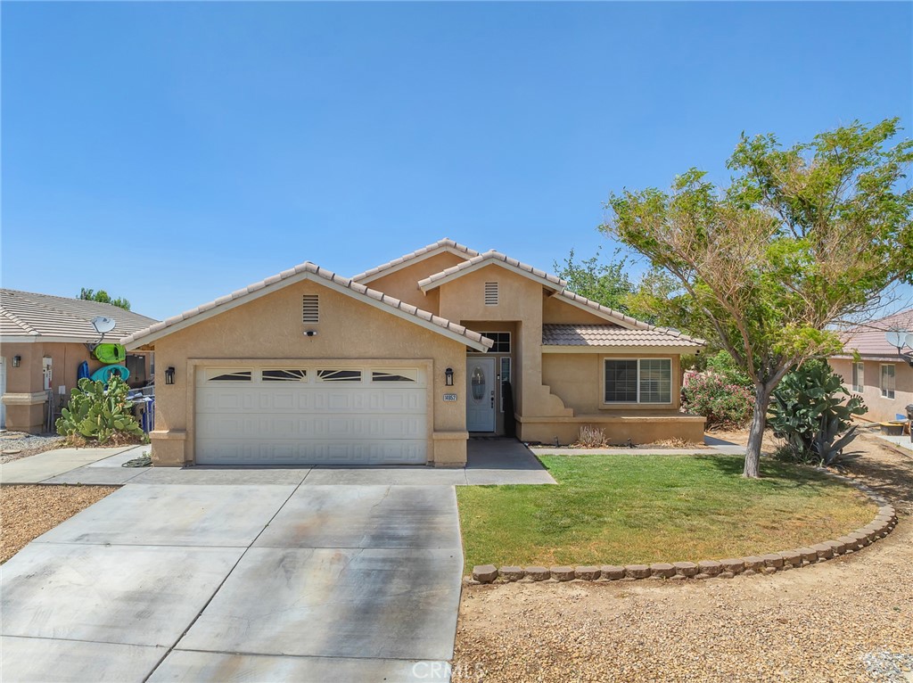 14952 Rivers Edge Road Helendale, CA 92342 - Photo 2 of 33 a view of a white house with a yard and large tree