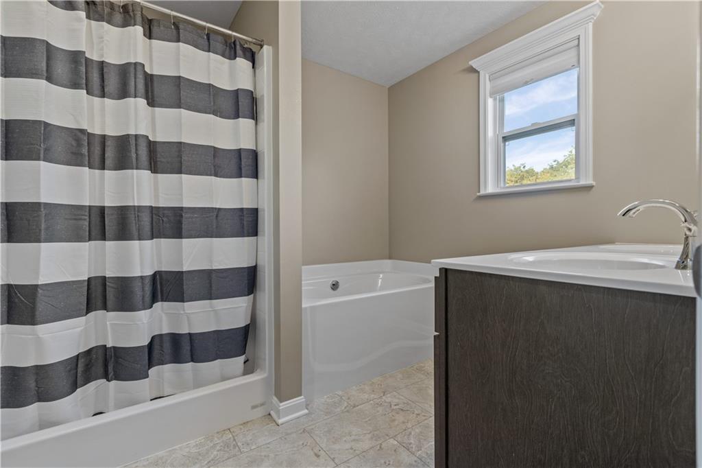 226 Lockheed Drive Coraopolis, PA 15108 - Photo 16 of 25 a bathroom with a bathtub and a shower